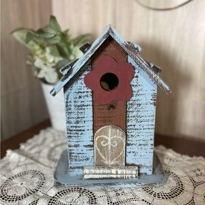 Rustic Handcrafted Blue and Brown Birdhouse with Red Flower
